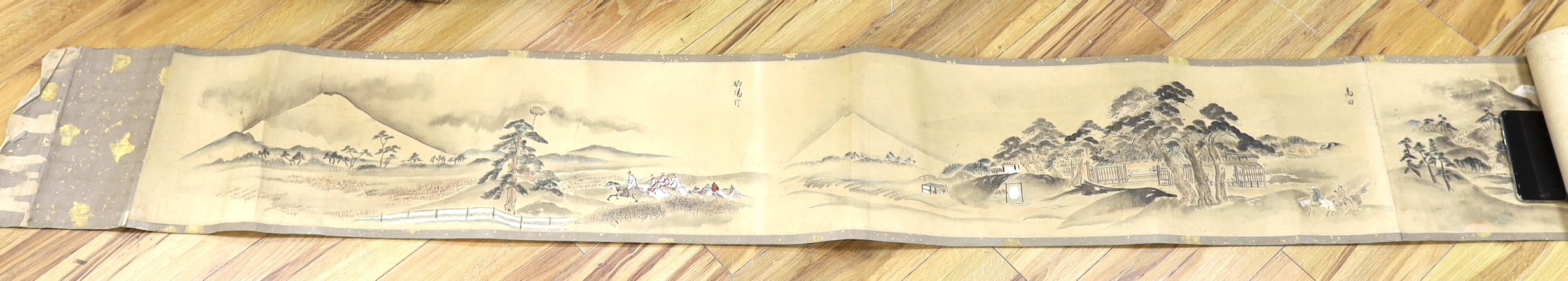A Japanese landscape painting on paper hand scroll, Edo period, titled views, now in two parts, incomplete, image 27cm high x approximately 470cm wide